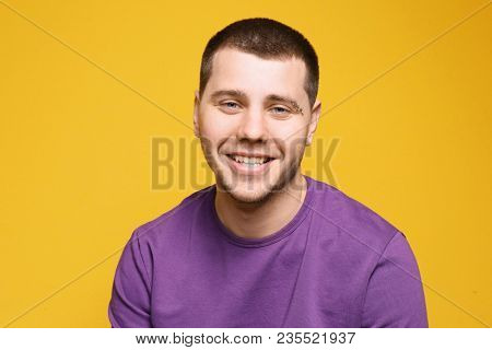Portrait of young man with pierced eyebrow on color background