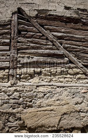 Stone Wall With Stone, Wood And Mud Background
Rustic Wall In A Old Construction With Stone, Wood An