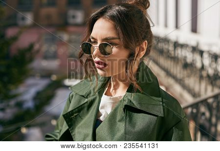 Beautiful Elegant Brunette Woman Wearing Green Coat On The Balcony
