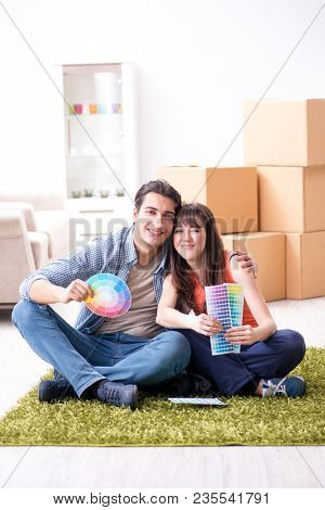 Young family choosiing colours for new apartment