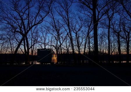 Peaceful Quiet Scene Of A Solitary Camper In The Forest At Dusk.