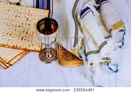 Kosher Wine With A White Plate Of Matzah Or Matza And A Passover Haggadah On A Vintage Wood Backgrou