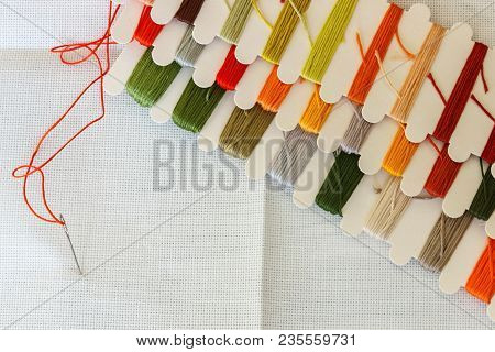 Set Of Multicolored Threads For Sewing And Embroidering On A Wooden Background. Hobbies, Clothes Rep