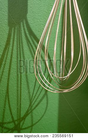Different Kitchen Tools For Cooking Hanging On The Wall
