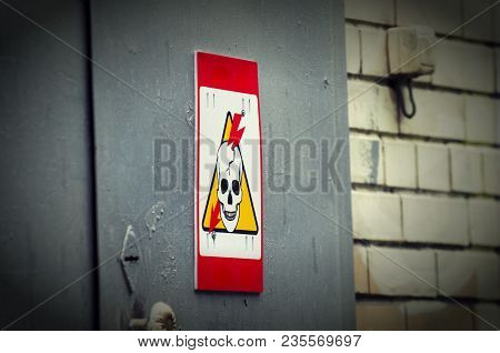 High Voltage Danger Yellow Sign On A Brick Wall Building