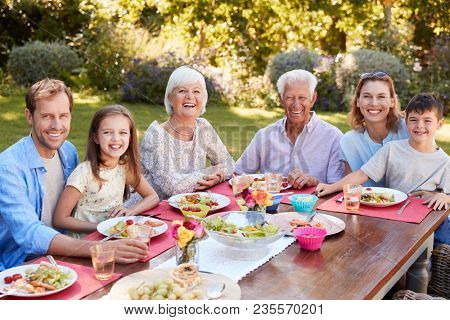Three generation family having lunch in the garden