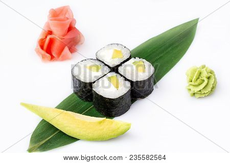 Delicious Fresh Mini-rolls With Avocado And Cheese On A Banana Leaf. Sushi Rolls On A White Backgrou