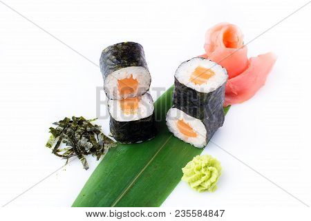 Delicious Fresh Mini-rolls With Salmon On A Banana Leaf. Sushi Rolls On A White Background With Ging