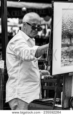 Paris, France - July 06, 2017: The Painter Works At The Open Air Artist Market At The Tertre Square 