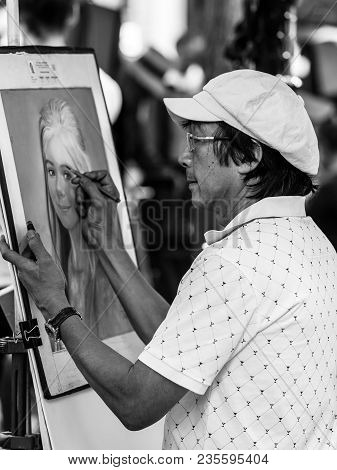 Paris, France - July 06, 2017: The Painter Works At The Open Air Artist Market At The Tertre Square 