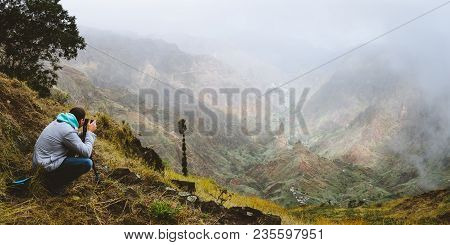Panoramic Shot Of Traveler Making Photo Of Amazing Steep Mountainous Terrain With Lush Canyon Valley
