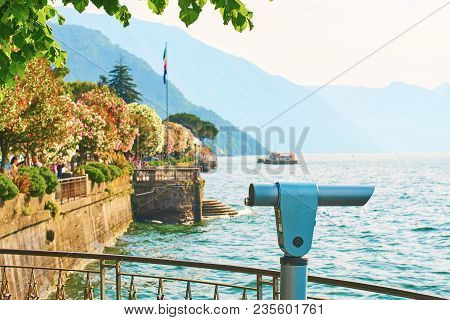 Public Telescope At Observation Point In Beautiful Bellagio Town At Lake Como In Italy With Blooming