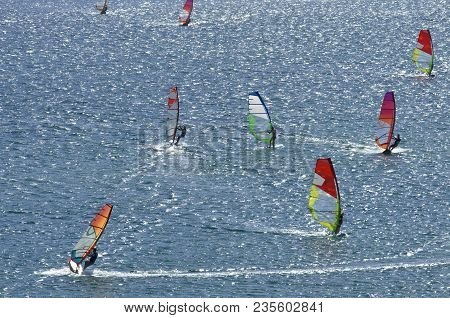 Eight Surfers Ride The Brilliant Waves Of The Beautiful Mediterranean Sea On Cape Prasonisi (rhodes,
