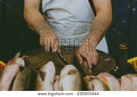 Fresh Market Scene In Malaysia, Fish Monger Clening His Fish Before Selling Activity.image May Conta
