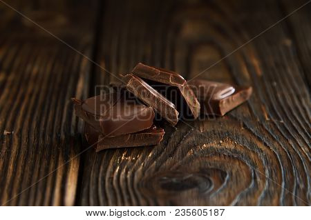 A Block From Delicious Dark Chocolate Bar Pieces On A Wooden Dark Old Table In Style Moodle