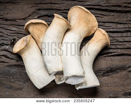 King oyster mushrooms on the wooden background.