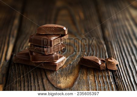 A Block From Delicious Dark Chocolate Bar Pieces On A Wooden Dark Old Table In Style Moodle