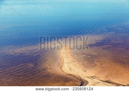 Sandy Shoreline And Sandbanks In The Water.