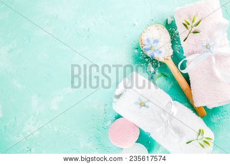 Spa Relax And Bath Concept, Sea Salt, Soap, With Cosmetics And Towels On Light Blue Conrete Backgrou
