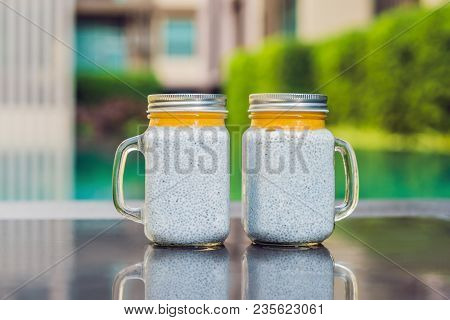 Healthy Layered Dessert With Chia Pudding And Mango Morning On The Background Of The Pool.