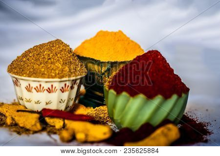 Close Up Of Three Basic Spices Of Indian Asian Food That Are Red Pepper Powder, Turmeric Powder And 