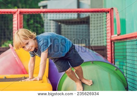 Adorable Little Toddler Boy Having Fun On Playground.