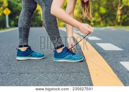 Female Runner Tying Her Shoes Preparing For Jogging Outside .young Girld Runner Getting Ready For Tr