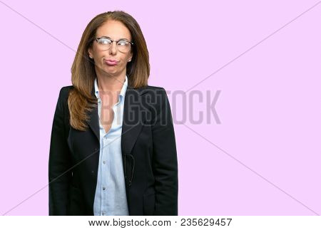 Middle age business woman making funny face fooling