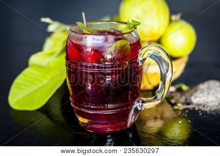 Close Up Of Popular Indian Shrabat Of Guava With Sugar And Masala In A Glass With Raw Fresh Guava On