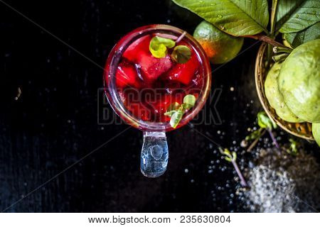 Close Up Of Popular Indian Shrabat Of Guava With Sugar And Masala In A Glass With Raw Fresh Guava On