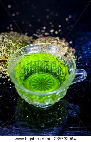 Closes Up Of Essential Tea Of Raw Fresh Fennel Seeds With Raw Fennel Seeds In A Transparent Cup On W
