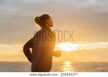 Zealous Young Girl Runs Along The Quay At Sunset, Leads A Healthy Lifestyle, A Lot Of Energy