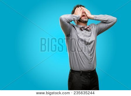 Middle age man, with beard and bow tie stressful keeping hands on head, tired and frustrated