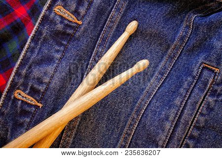 Drum Sticks Lie On A Scottish Cage And Jeans