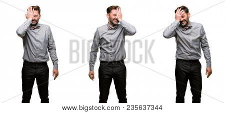 Middle age man, with beard and bow tie stressful keeping hand on head, tired and frustrated