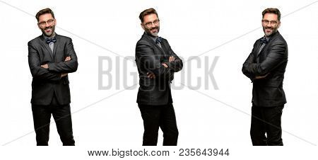 Middle age man, with beard and bow tie with crossed arms confident and happy with a big natural smile laughing