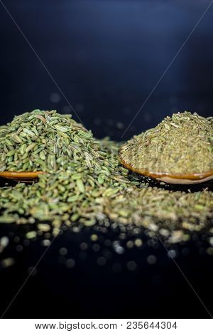 Close Up Of Raw Dried Fennel Seeds Or Variyali Or Foeniculum Vulgare On A Wooden Surface With Its Po