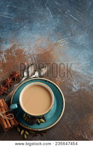 Indian Masala Chai Tea. Spiced Tea With Milk On Dark Rusty Background.