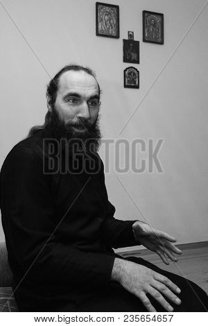 Kupychiv, Ukraine - 30 January 2009: Christianity Priest With Beard In Cassock Posing At Home