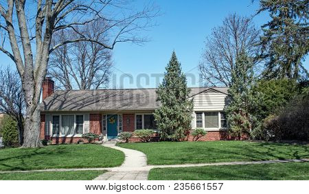 Brick Ranch Home Nestled in Trees with Curved Walk