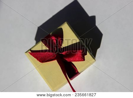 A Small Box With A Shadow, A Yellow Box For A Ring, A Small Box With A Red Bow, A Box For A Ring.