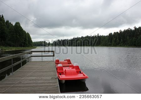Beautiful Calm Lake Landscape With A Catamaran.