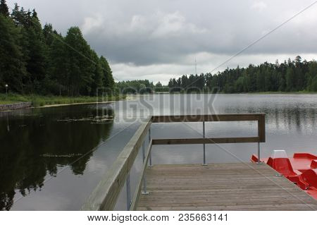 Beautiful Calm Lake Landscape With A Catamaran.