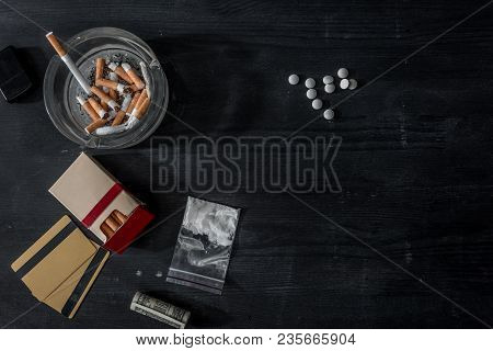 Top View Of Mdma Pills, Cocaine And Cigarettes On Black Wooden Surface