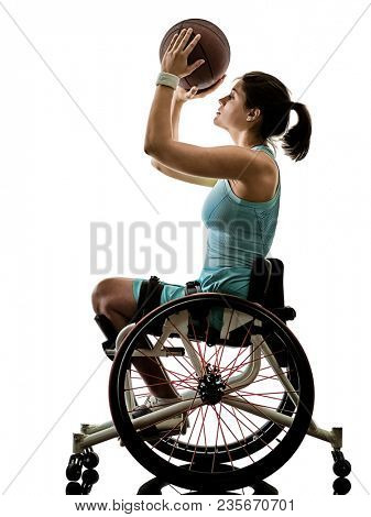 one caucasian young ped basket ball player woman in wheelchair sport  tudio in silhouette isolated on white background