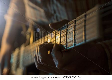 The Musician Is Playing The Guitar At A Concert