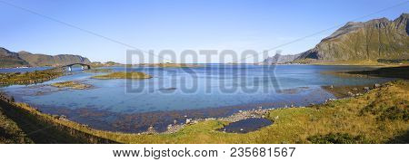 Panoramic View From Famous Fredvang Bridges To Ramderg In Autumn Sunny Day With Mountains In Backgro