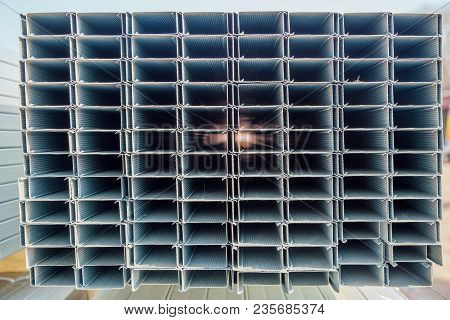 Construction Steel Profile Pipe Of Rectangular Shape With Corrugated Surface In Warehouse.
