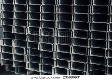 Construction Steel Profile Pipe Of Rectangular Shape With Corrugated Surface In Warehouse.