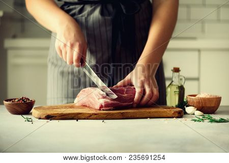 Wooman Hands Cutting Beef Meat On Wooden Chopping Board, Rosemary, Oil, Salt, Pepper. Girk Cooking P